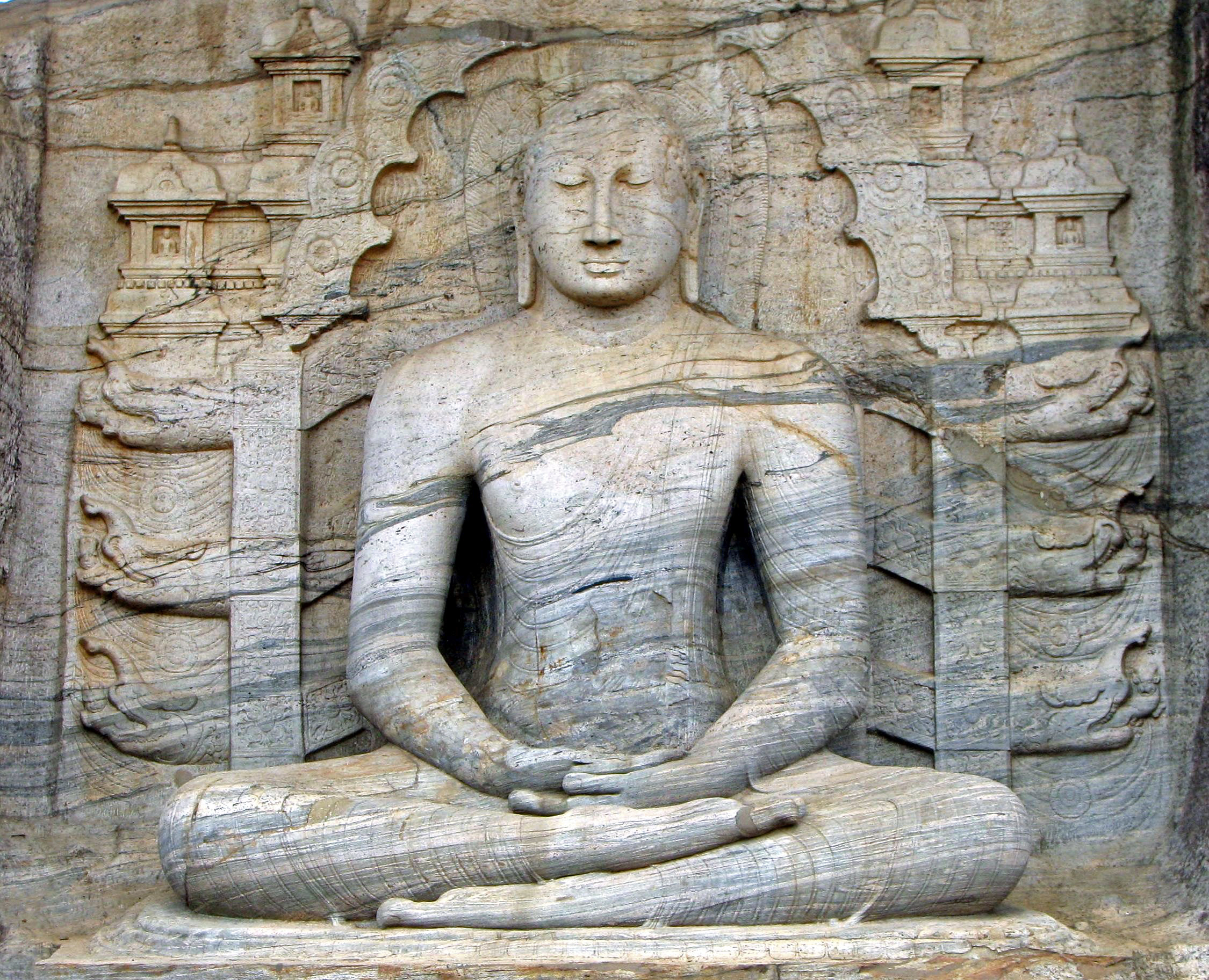 Image of ancient statue in lotus position